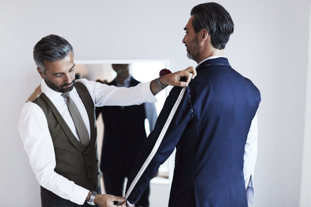 Alessandro Albanese fitting a client for a custom riding coat