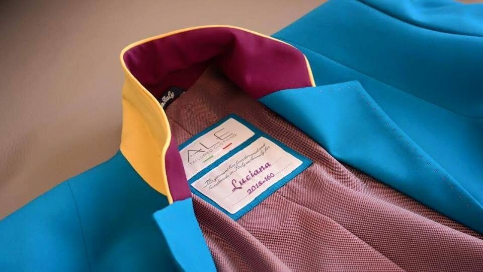 Close-up of Alessandro Albanese's detailed stitching and personalized ALE label on a riding coat for Luciana Diniz