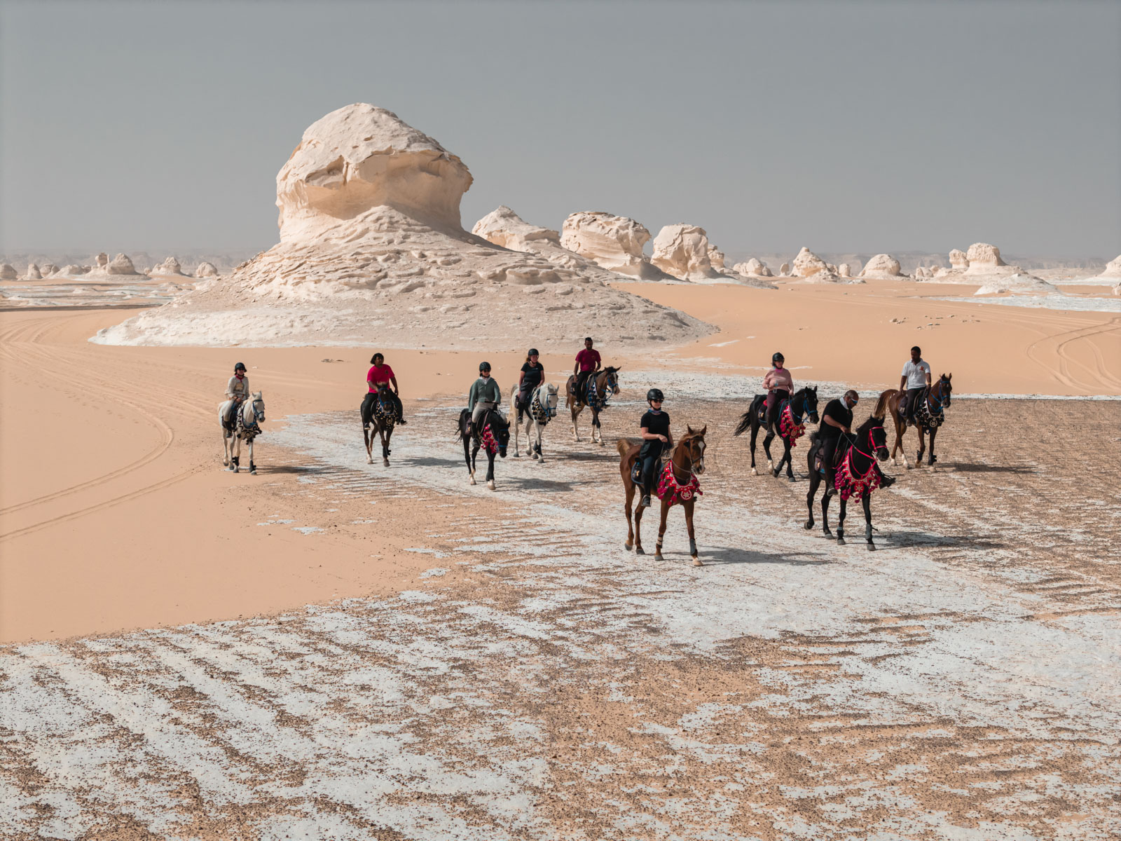 Riders on horseback crossing Egypt's White Desert, aerial view