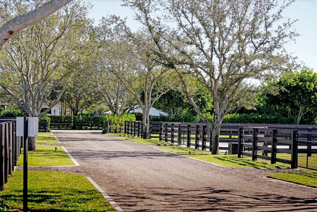 The tree-lined entrance to Team Welles Farm in Wellington, Florida