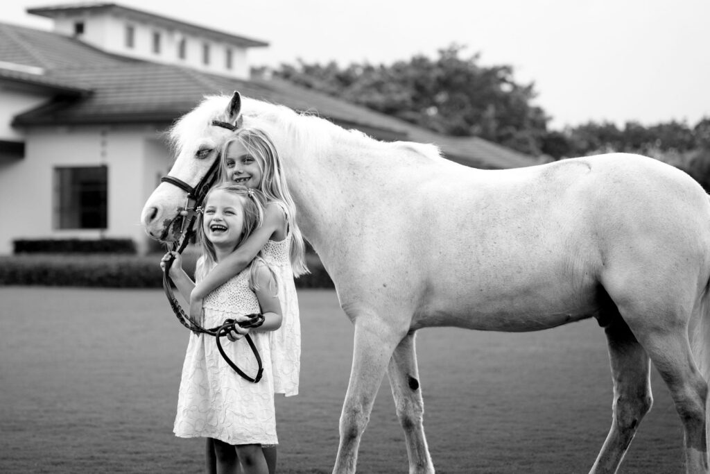 Anderson and Adeline Welles hug the family pony