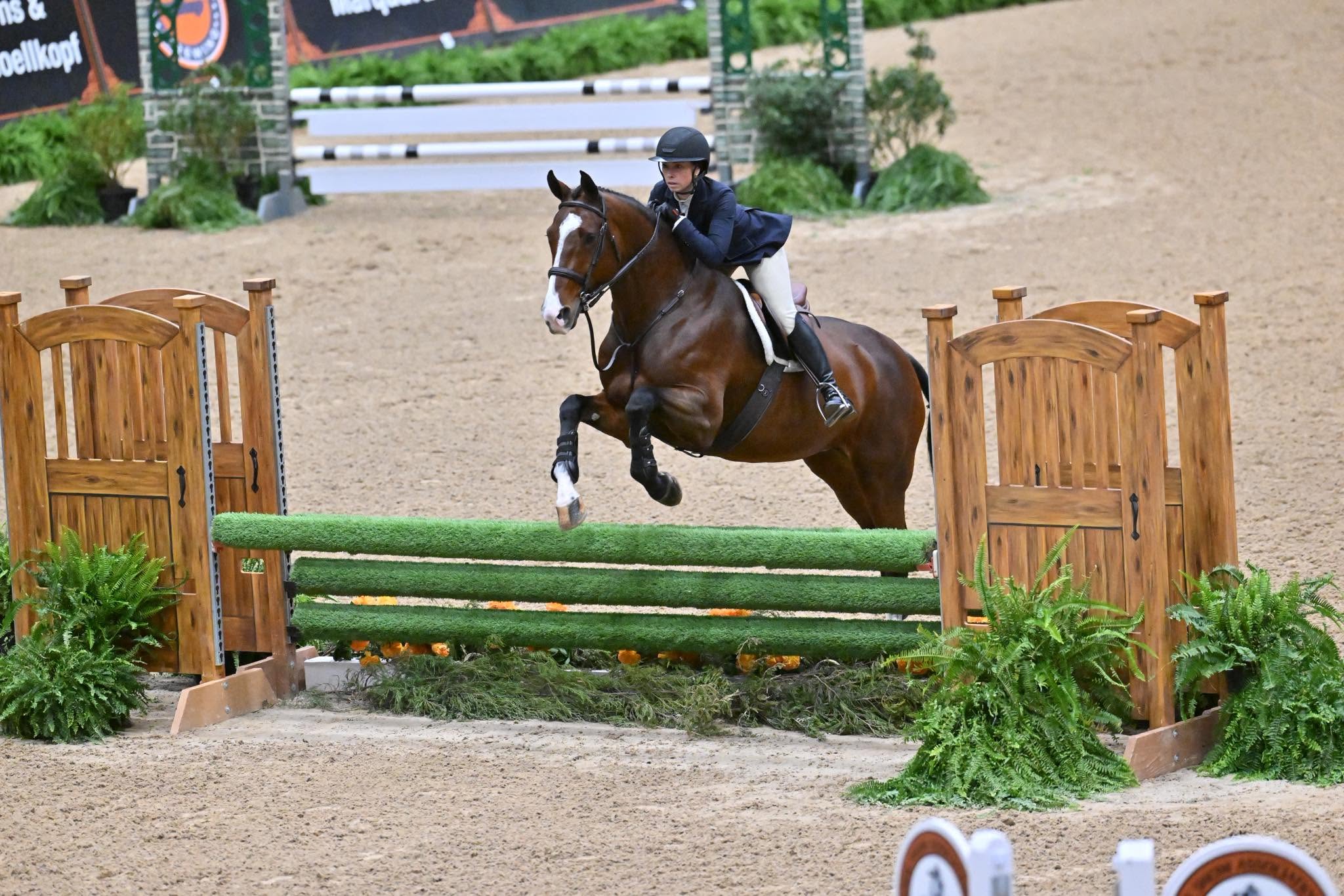 Kristina Christiansen riding Cordoba 73 over a gate fence at the 2025 National Horse Show