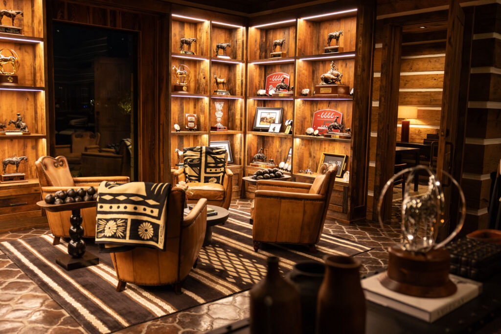 Western-style lounge with leather chairs and trophy shelves at the Four Sixes